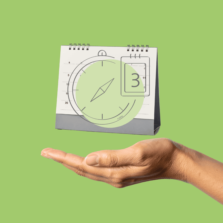 Hand mit offener Handfläche unter einem kleinen Tischkalender vor grünem Hintergrund